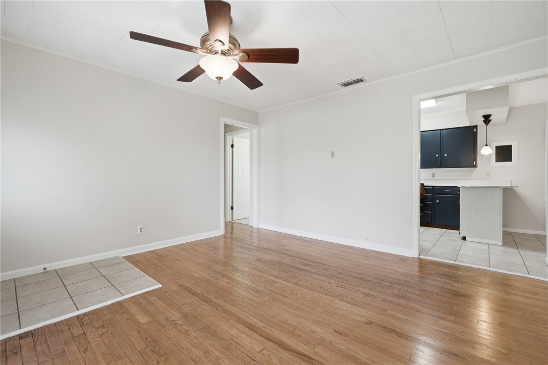 804 Edwards Street Sinton, TX 78387 - Photo 8 of 25 wooden floor in an empty room with a fireplace