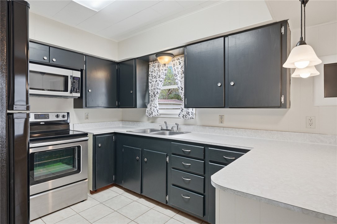 804 Edwards Street Sinton, TX 78387 - Photo 9 of 25 a kitchen with a sink stove and microwave