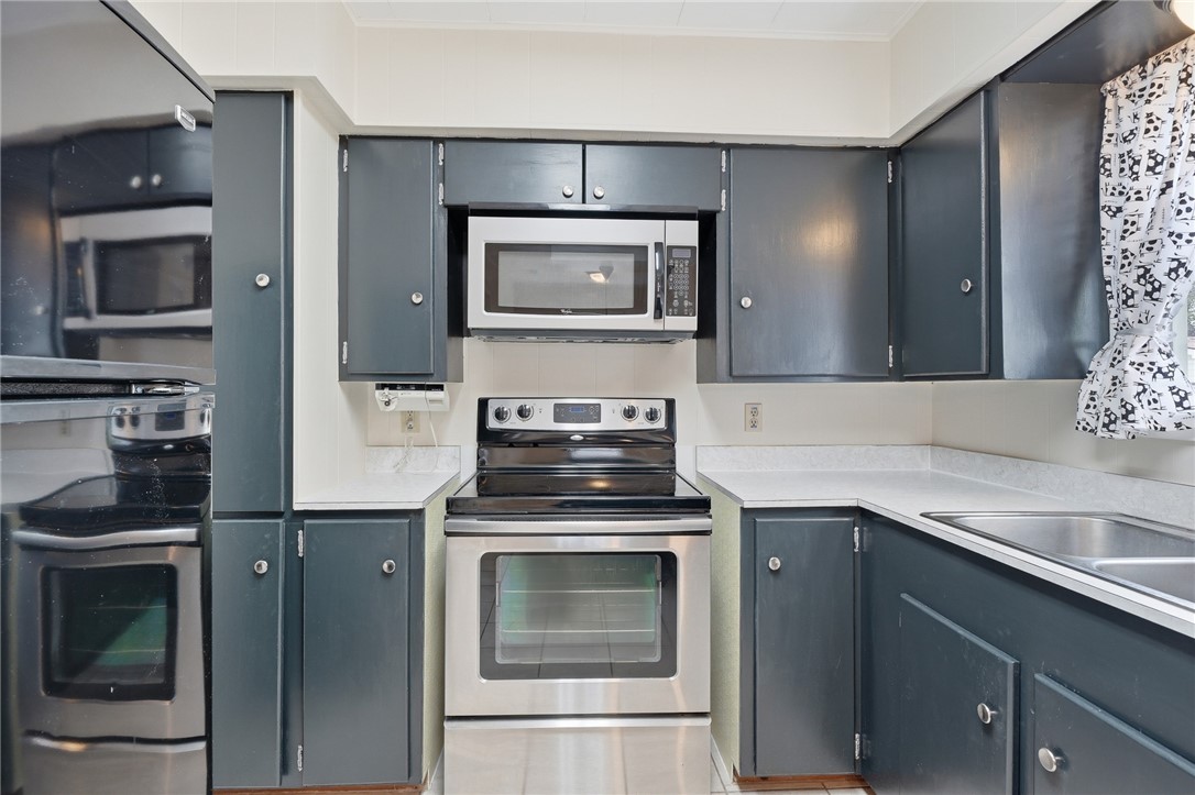 804 Edwards Street Sinton, TX 78387 - Photo 10 of 25 a kitchen with a stove and a microwave