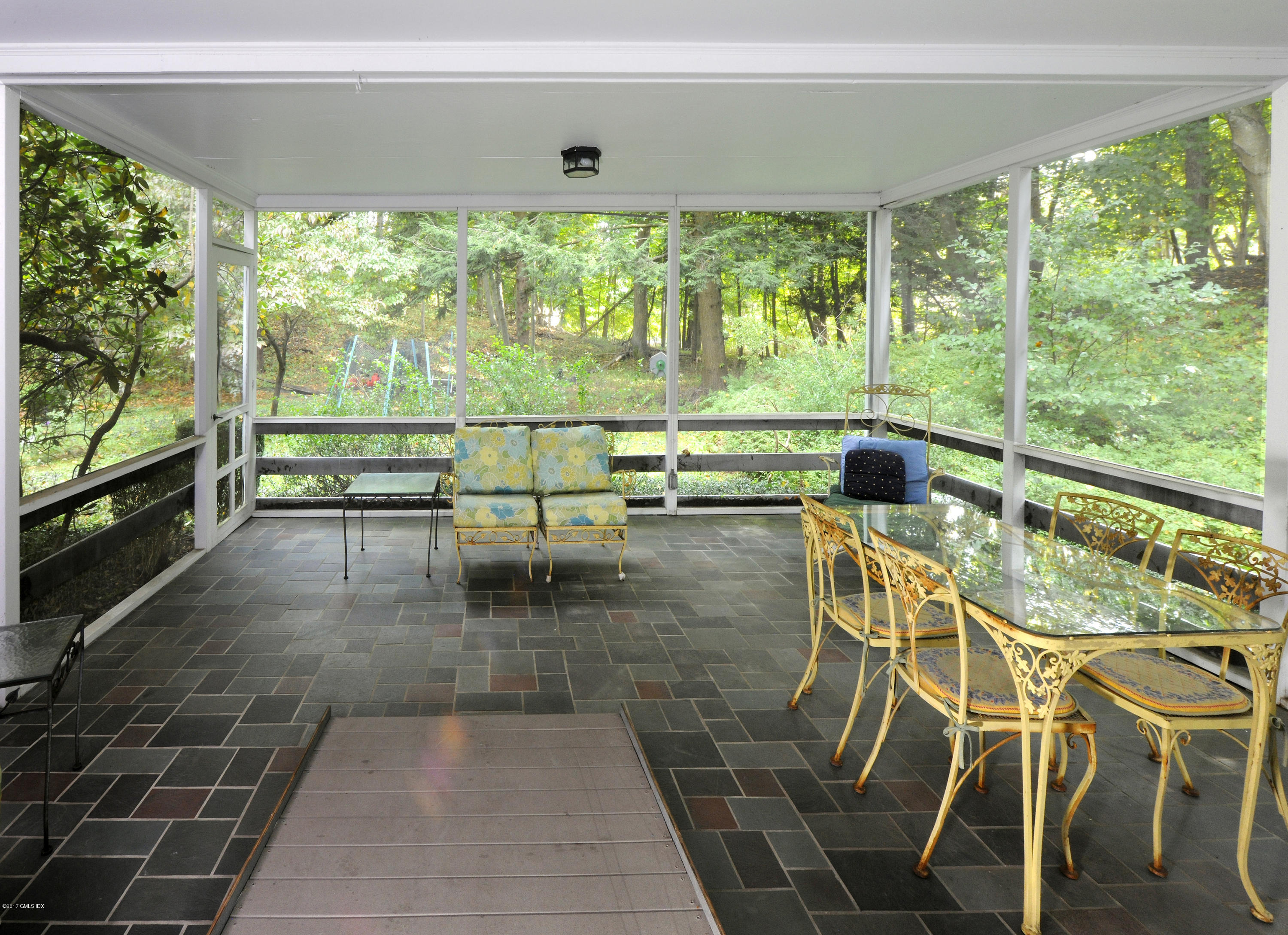 2 Hunting Ridge Road Greenwich, CT 06831 - Photo 8 of 14 a living room with a floor to ceiling window and an outdoor view