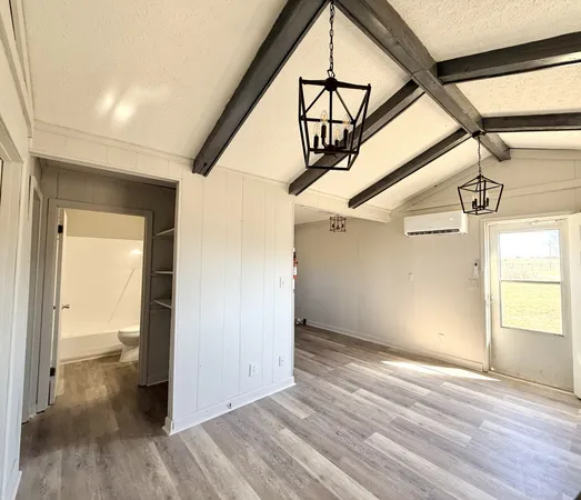 a view of hallway with wooden floor and stairs