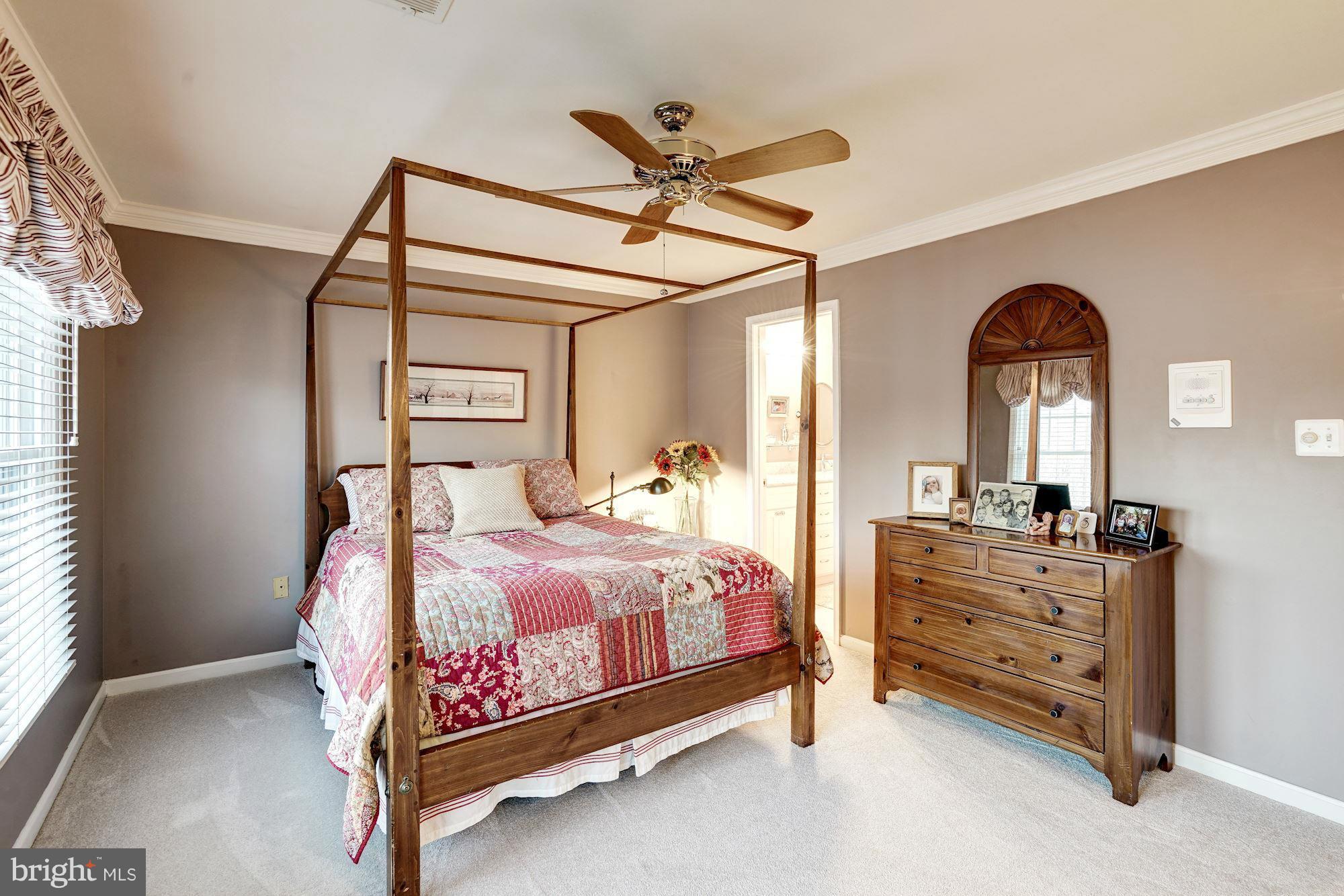 1256 Weatherstone Court Reston, VA 20194 - Photo 14 of 30 a bedroom with a bed and a chandelier