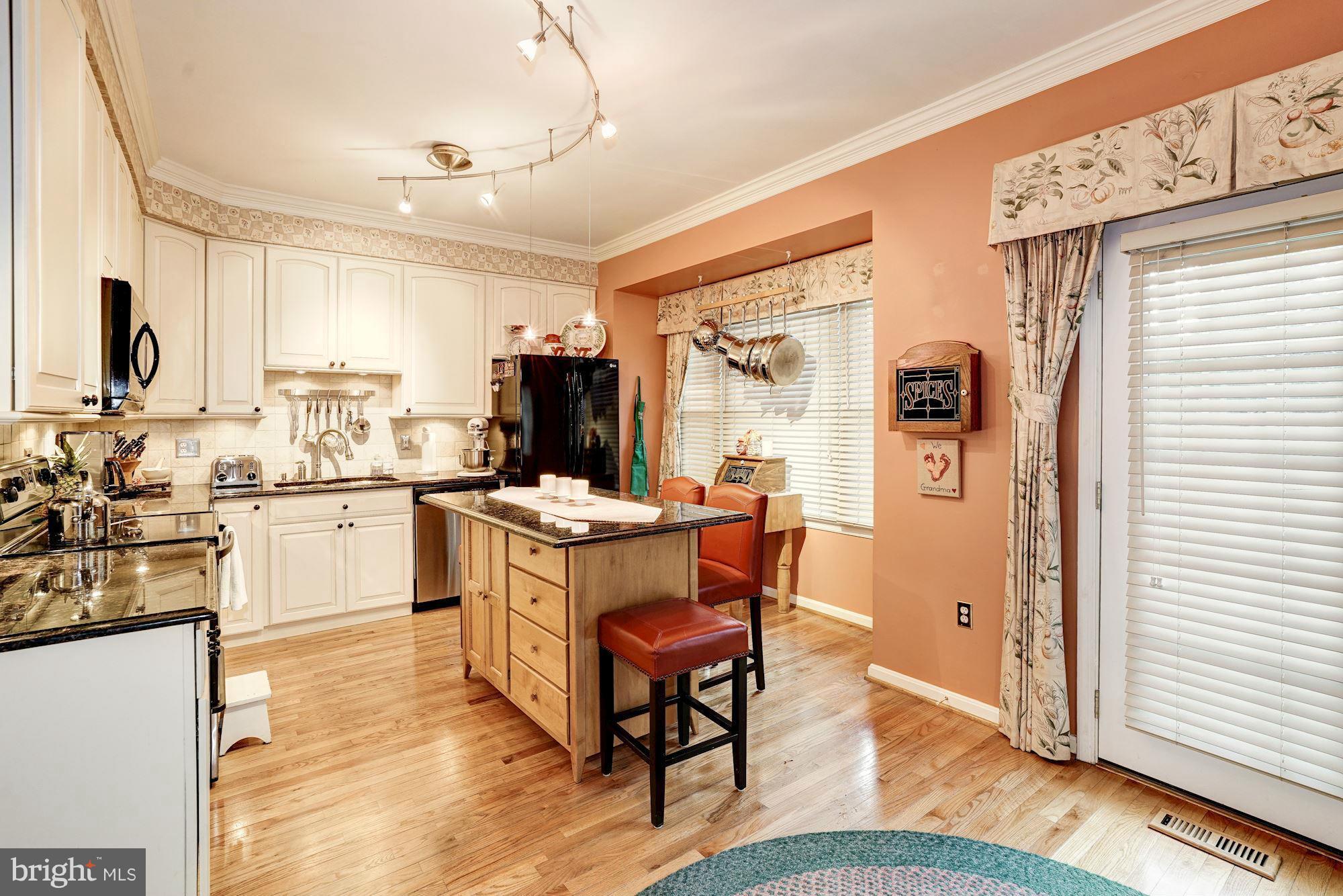 1256 Weatherstone Court Reston, VA 20194 - Photo 8 of 30 a kitchen with a sink stove and cabinets
