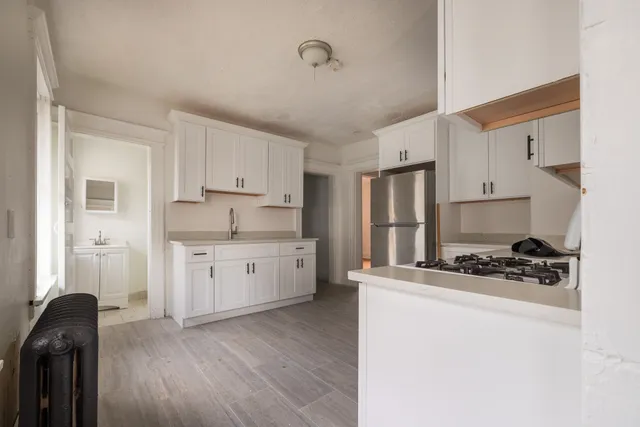 a kitchen with a sink stove and cabinets