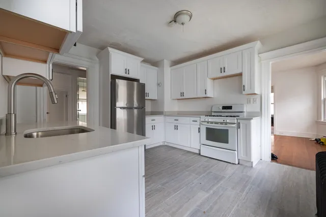 a kitchen with stainless steel appliances a refrigerator stove and sink