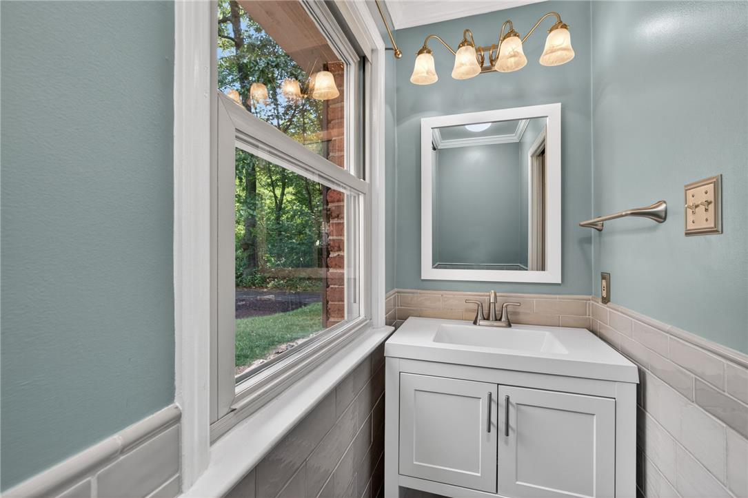 1371 Stoke Park Road Bethlehem, PA 18017 - Photo 28 of 55 a bathroom with a sink mirror and a window