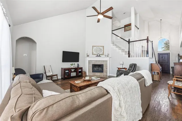 a living room with furniture a fireplace and a flat screen tv