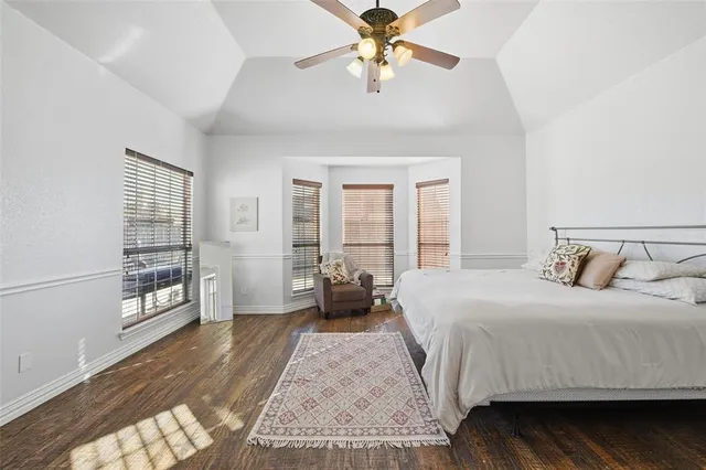 a bedroom with a large bed and a chandelier