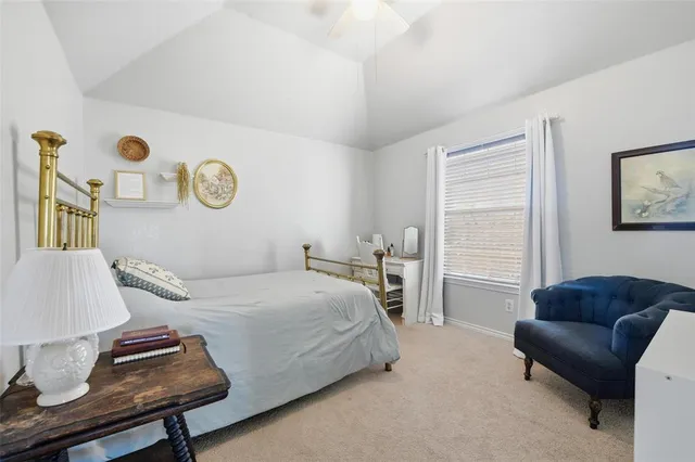 a bedroom with a bed and a dresser in it