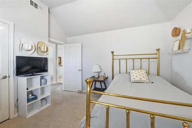 a bedroom with furniture and a flat screen tv