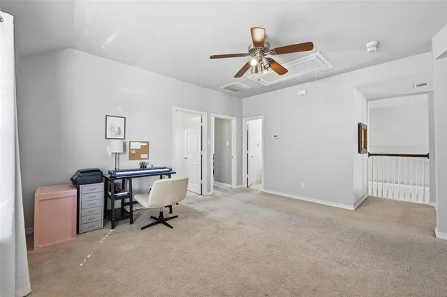 a view of a livingroom with furniture and a ceiling fan
