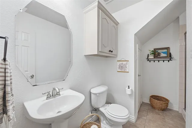 a bathroom with a sink toilet and mirror