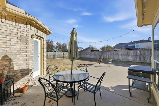 a patio with table and chairs