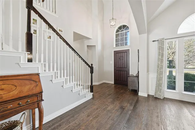 a view of an entryway with wooden floor and stairs