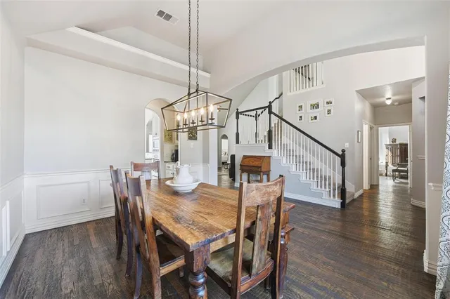 a view of a dining room with furniture wooden floor and chandelier