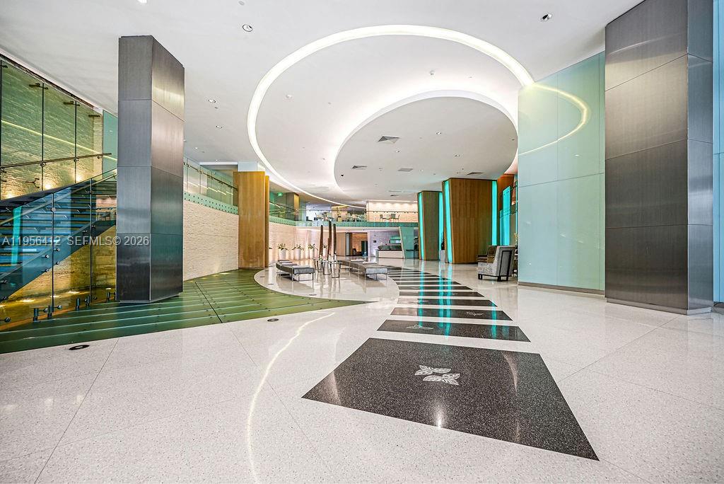 92 Southwest 3rd Street, Unit 4806 Miami, FL 33130 - Photo 19 of 20 a living room with a floor to ceiling windows and kitchen view