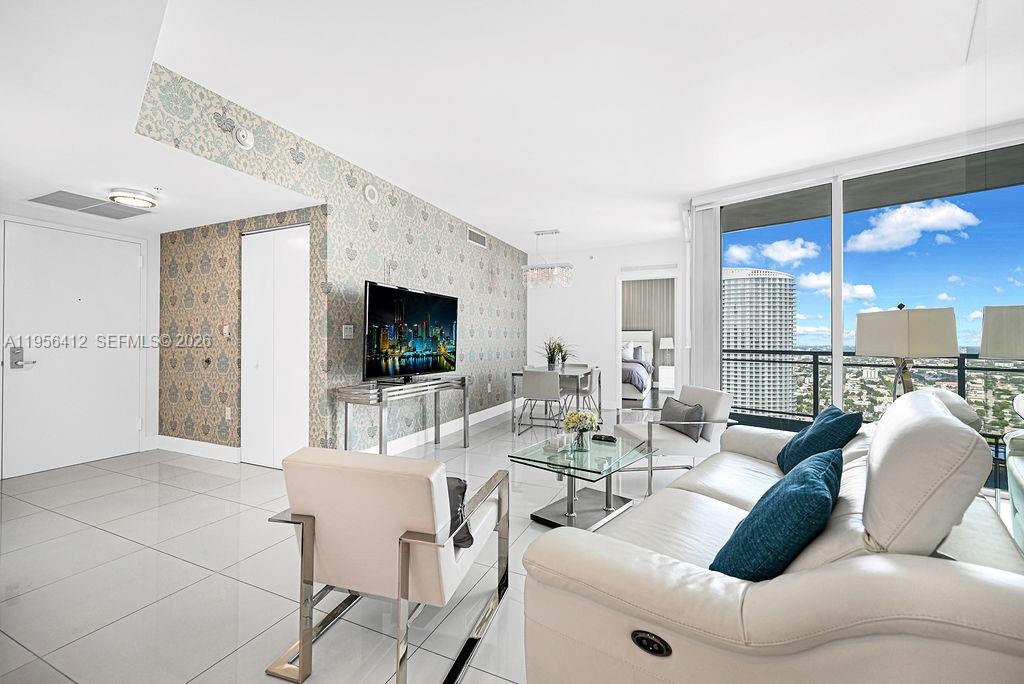 92 Southwest 3rd Street, Unit 4806 Miami, FL 33130 - Photo 3 of 20 a living room with furniture a flat screen tv and a large window
