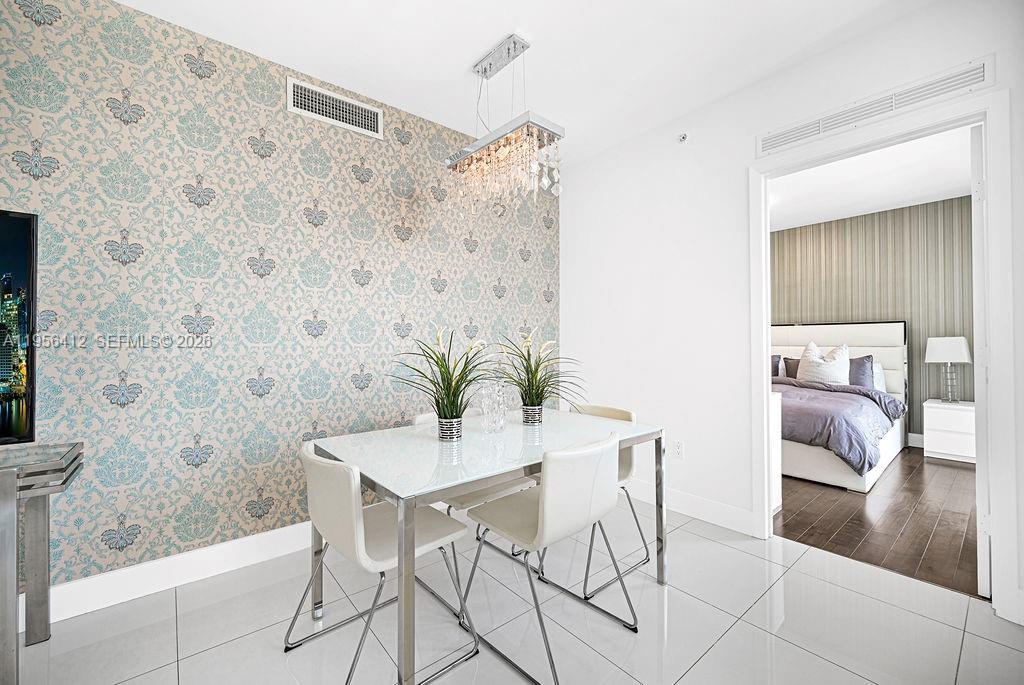 92 Southwest 3rd Street, Unit 4806 Miami, FL 33130 - Photo 5 of 20 a dining room with furniture and wooden floor