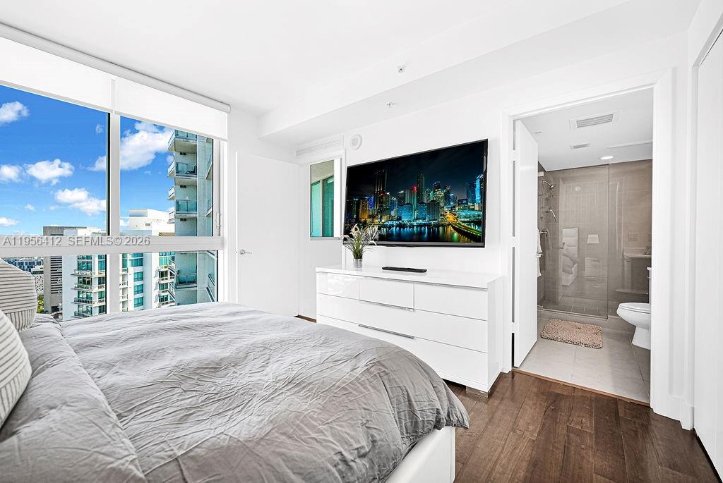 92 Southwest 3rd Street, Unit 4806 Miami, FL 33130 - Photo 7 of 20 a bedroom with a bed and a flat screen tv