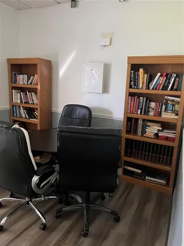 a living room with furniture and a bookshelf