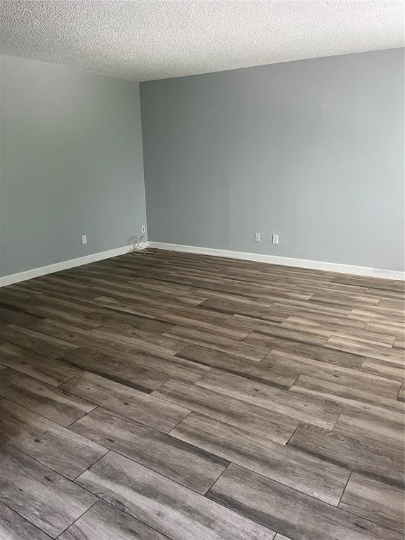 3300 Fox Chase Circle, Unit 213 Palm Harbor, FL 34683 - Photo 4 of 16 a view of a room with wooden floor