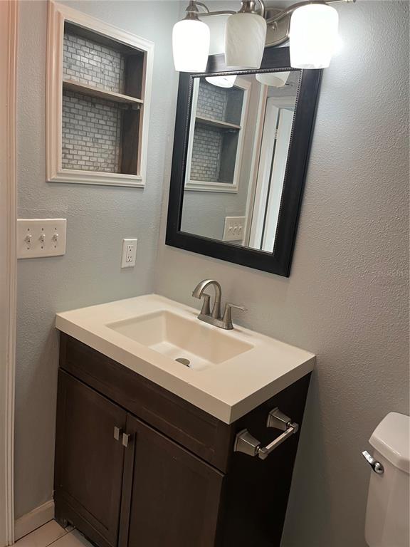 3300 Fox Chase Circle, Unit 213 Palm Harbor, FL 34683 - Photo 6 of 16 a bathroom with a sink and a mirror