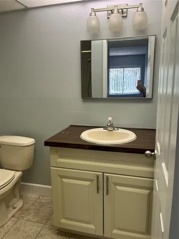 a bathroom with a sink toilet and mirror