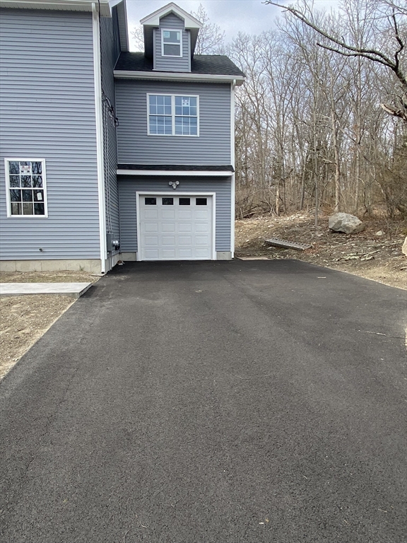 855 County Street, Unit 2 Attleboro, MA 02703 - Photo 2 of 27 a view of a house with a yard and garage