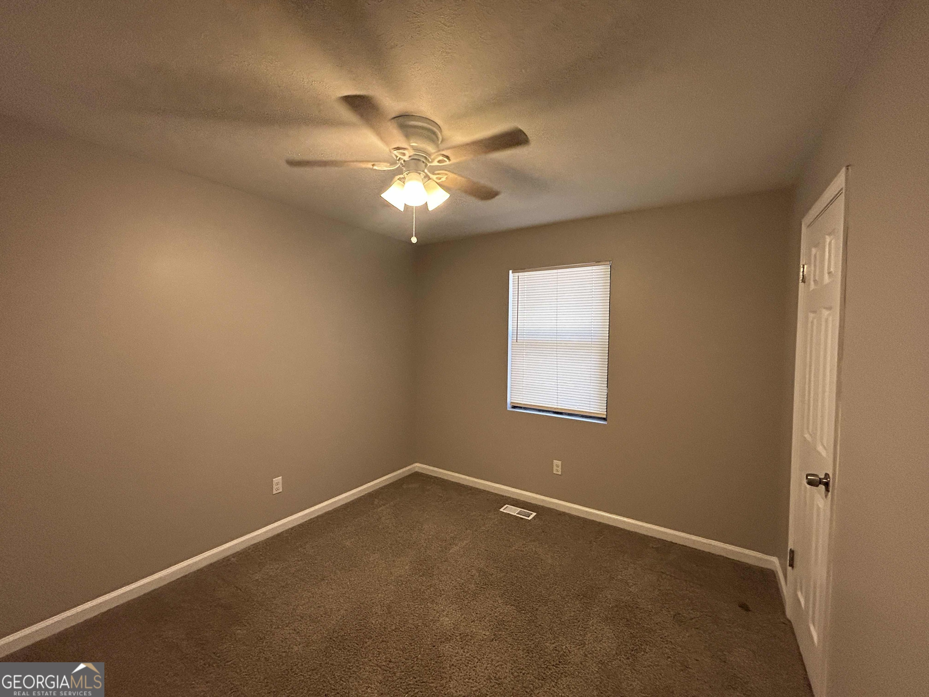 8937 Tweeddale Drive Winston, GA 30187 - Photo 11 of 26 an empty room with a window and a fan