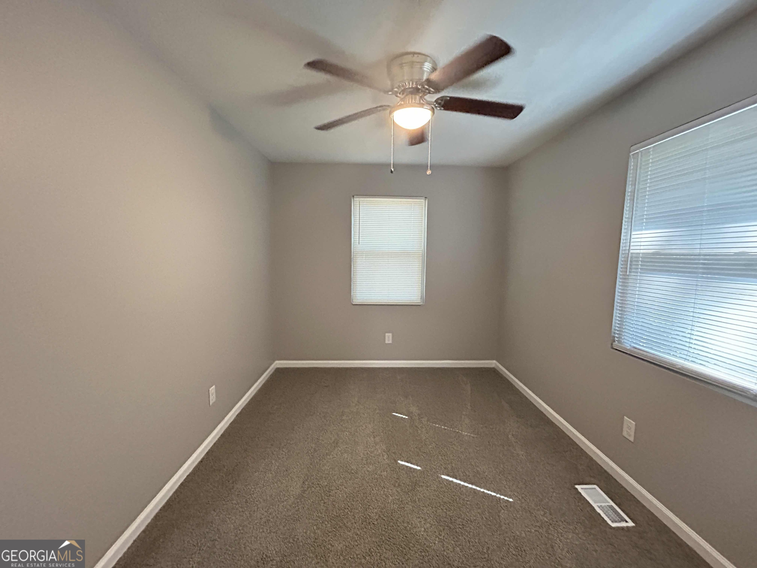 8937 Tweeddale Drive Winston, GA 30187 - Photo 13 of 26 an empty room with windows and chandelier fan