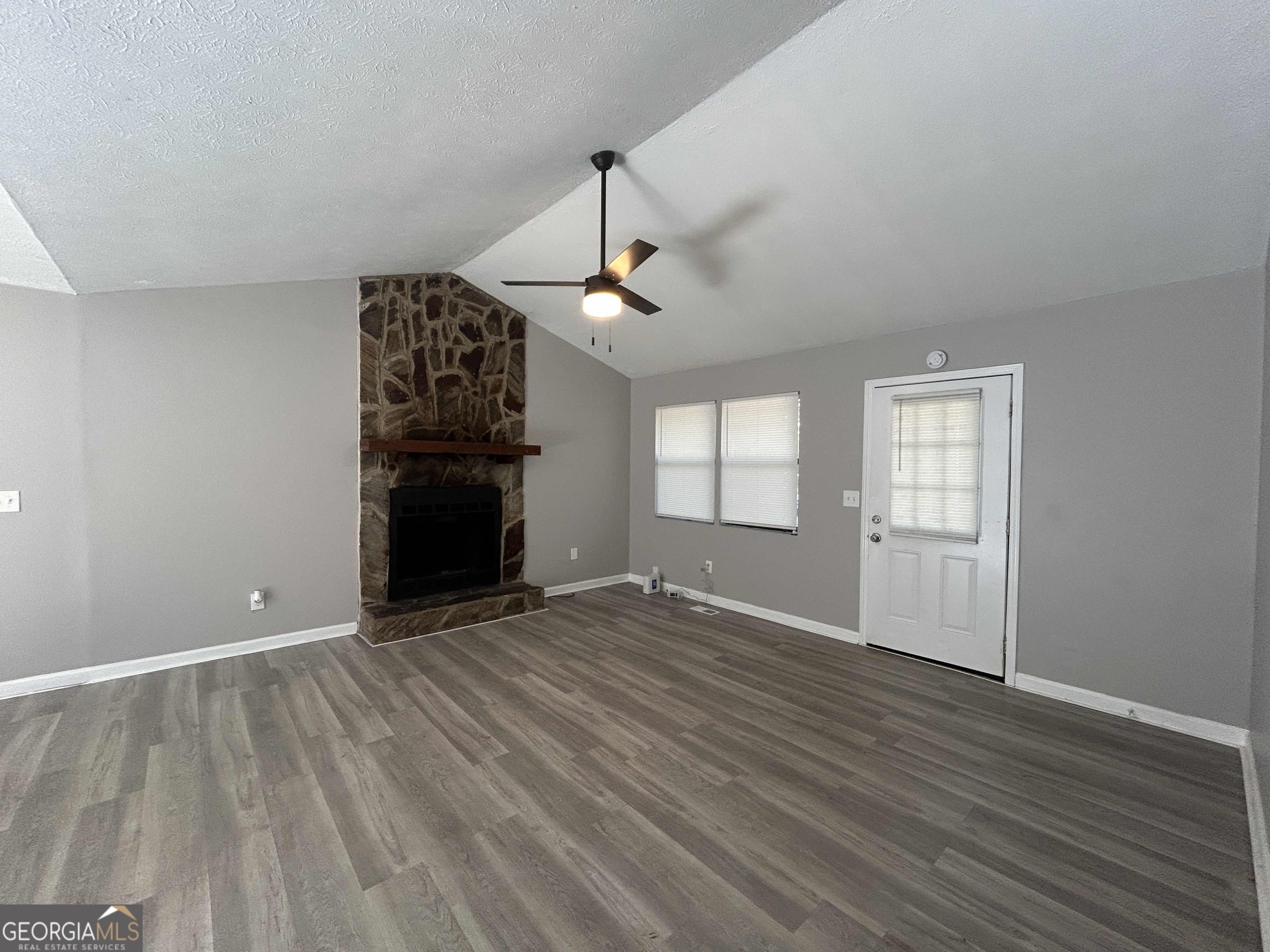 8937 Tweeddale Drive Winston, GA 30187 - Photo 2 of 26 an empty room with wooden floor ceiling fan and windows