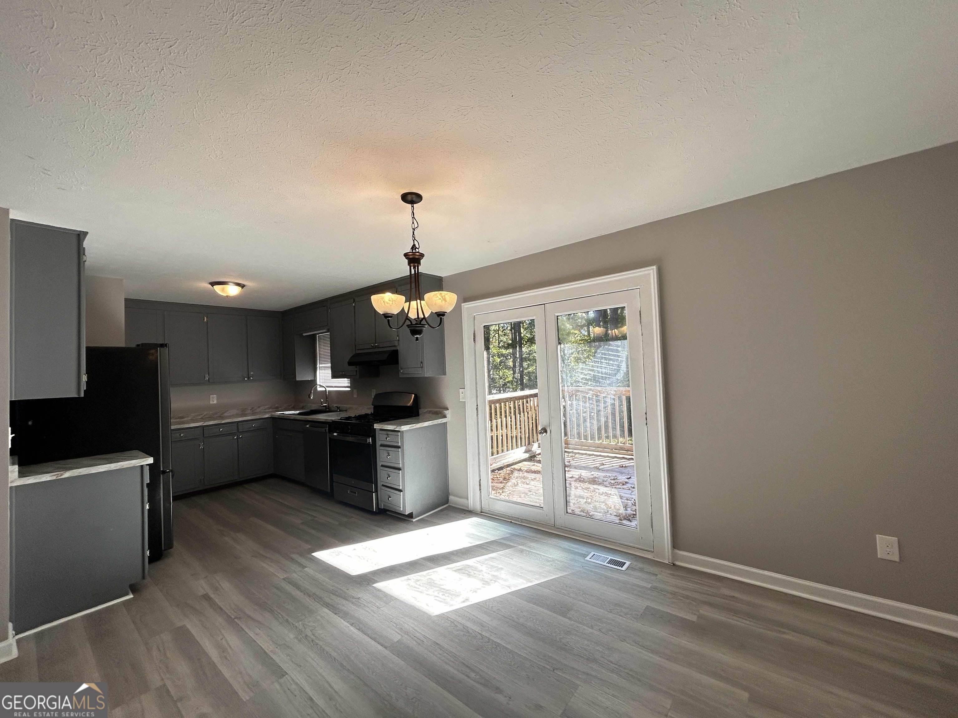 8937 Tweeddale Drive Winston, GA 30187 - Photo 5 of 26 a large kitchen with cabinets wooden floor and stainless steel appliances