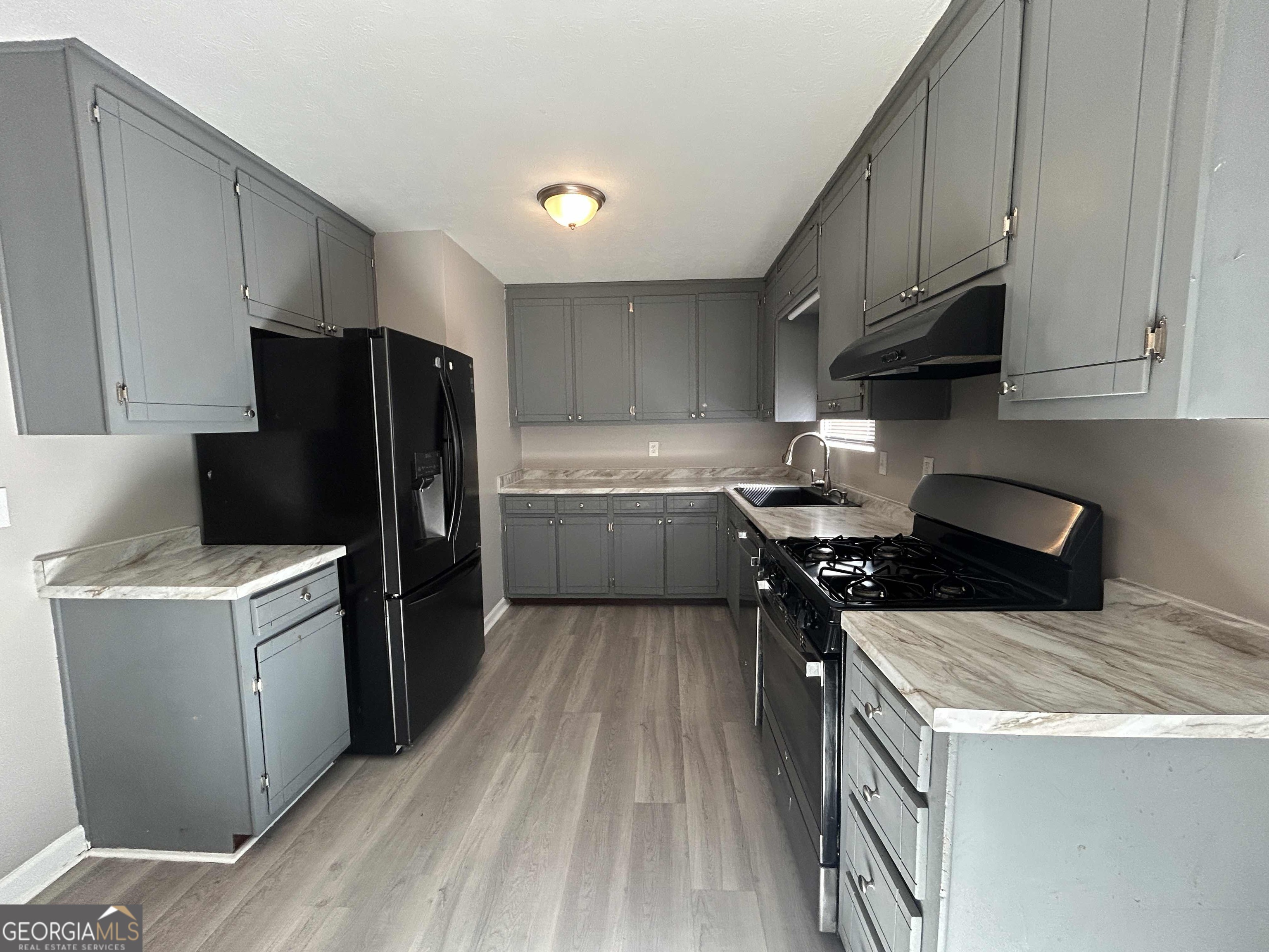 8937 Tweeddale Drive Winston, GA 30187 - Photo 8 of 26 a kitchen with a stove a refrigerator and a sink