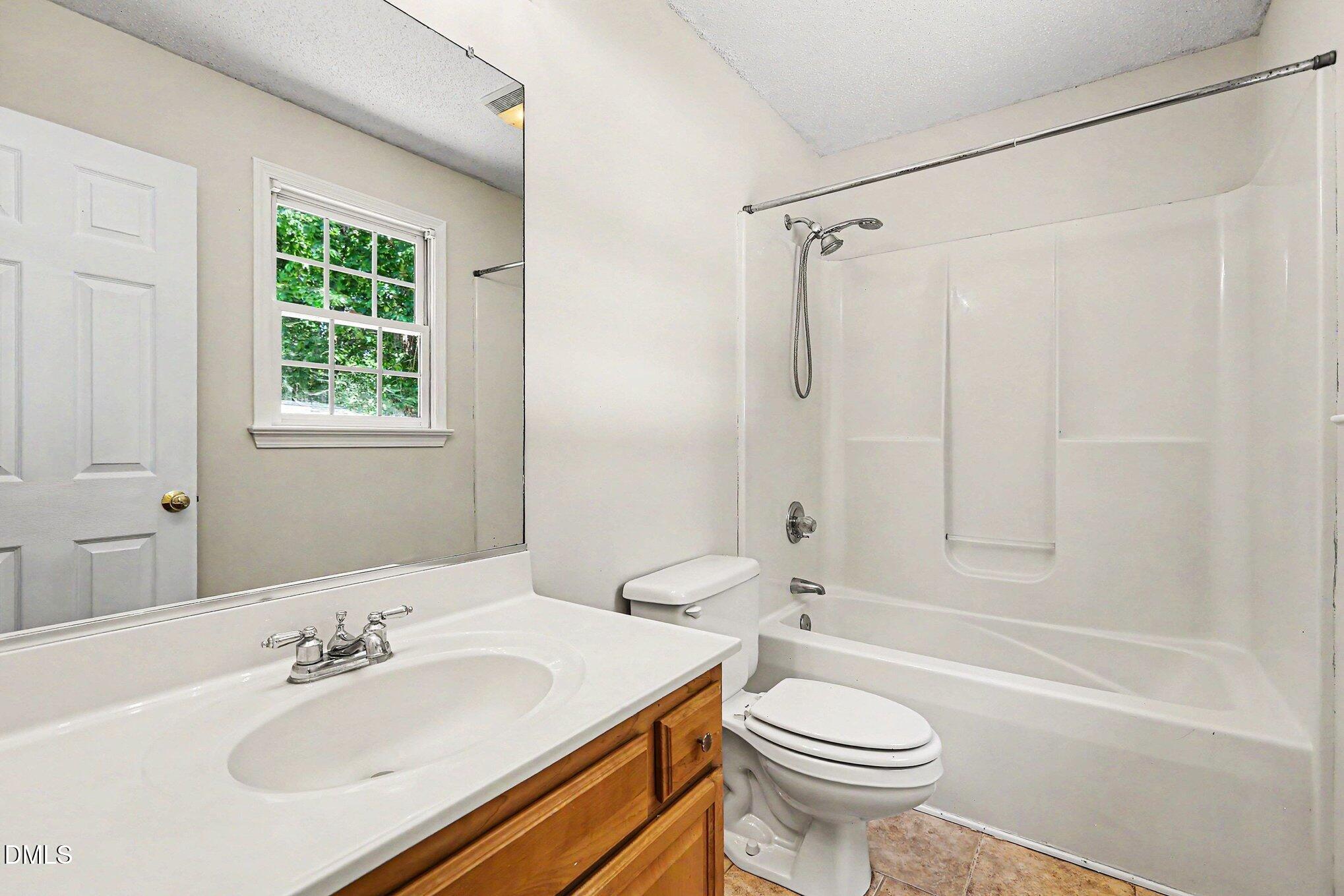 5359 Bass Mountain Road Snow Camp, NC 27349 - Photo 9 of 25 a bathroom with a sink toilet and shower