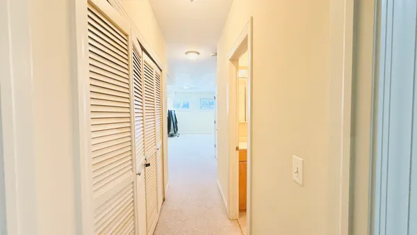 a view of a bathroom from a corridor