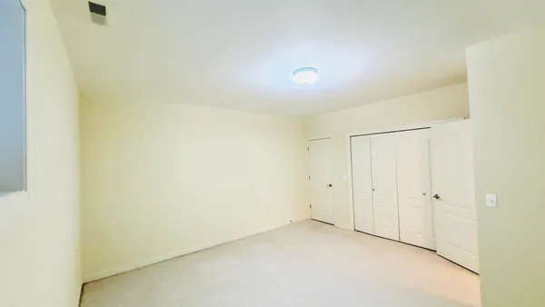 an empty room with white walls