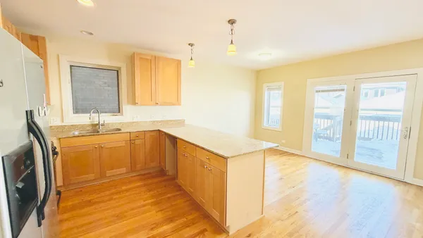 a kitchen with stainless steel appliances granite countertop a sink and wooden cabinets