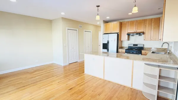 a kitchen with kitchen island a sink stainless steel appliances and cabinets