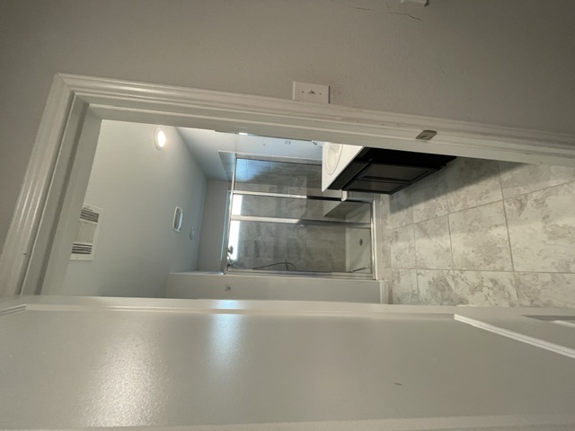 12401 Amber Lynn Path Manor, TX 78653 - Photo 14 of 33 Ceramic tile flooring enhances this modern bathroom with a glass-enclosed shower.