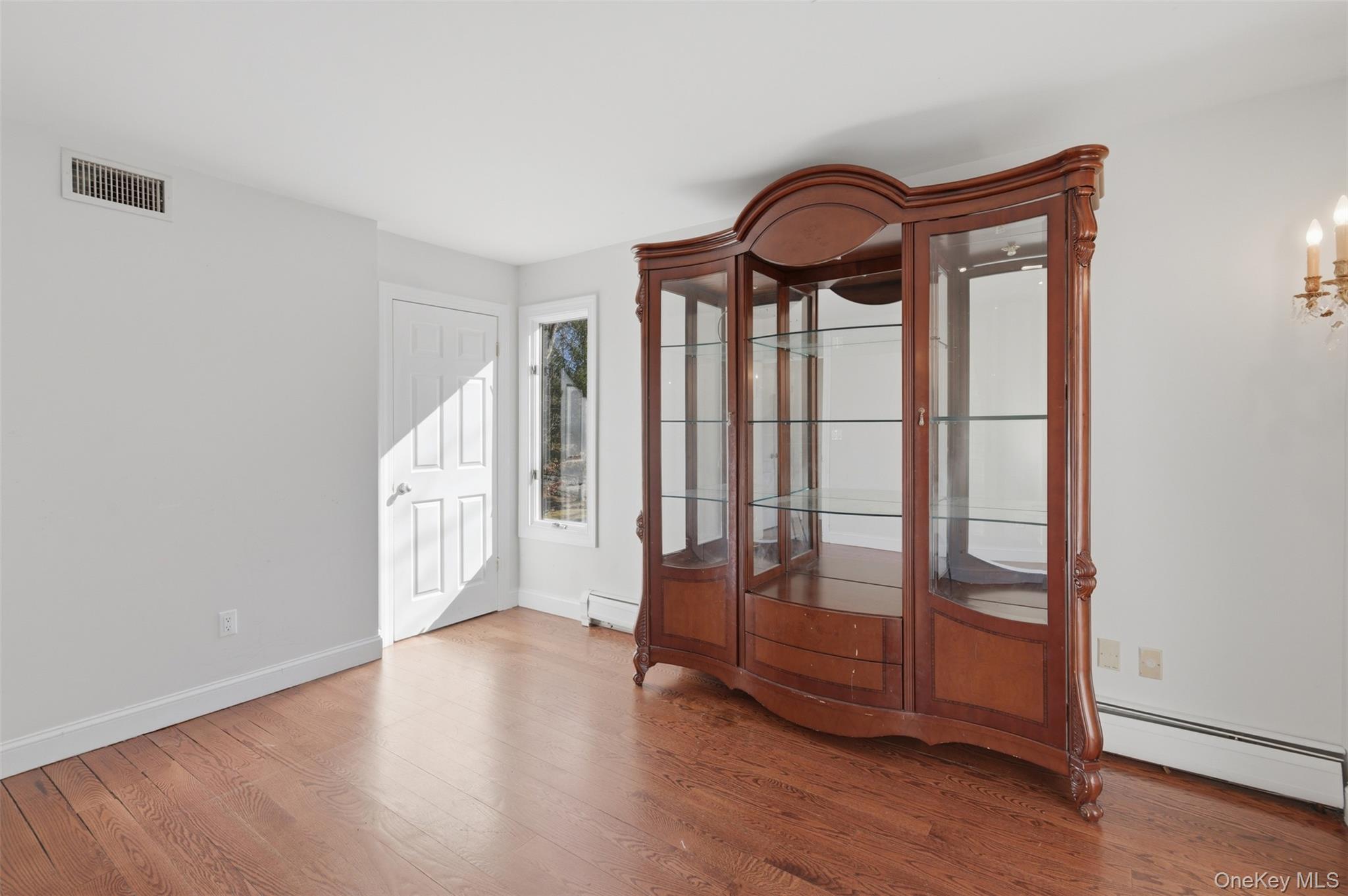 41 South Monsey Road Monsey, NY 10952 - Photo 13 of 50 a view of an empty room with wooden floor and window