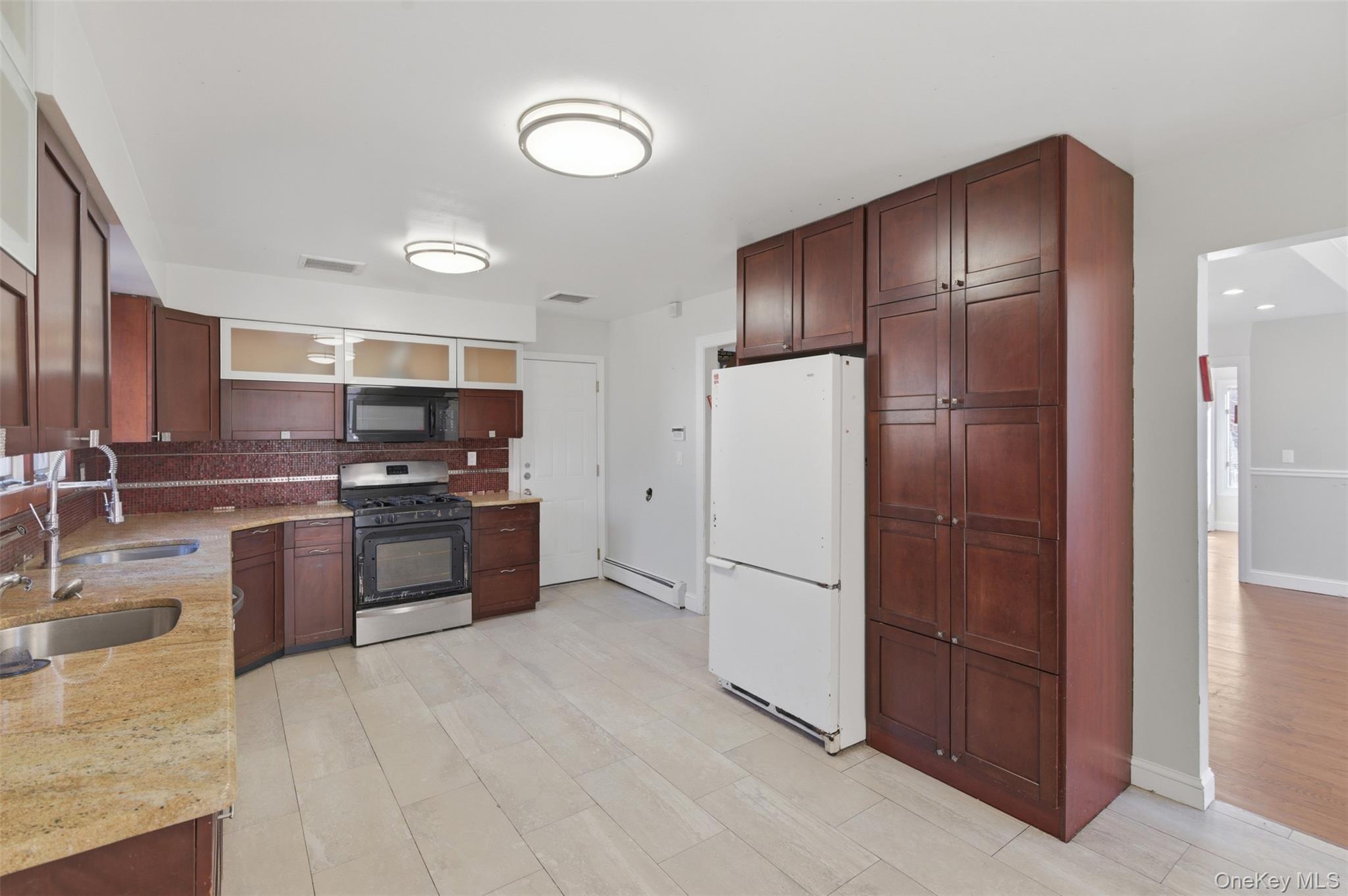 41 South Monsey Road Monsey, NY 10952 - Photo 15 of 50 a kitchen with stainless steel appliances granite countertop a refrigerator stove and oven