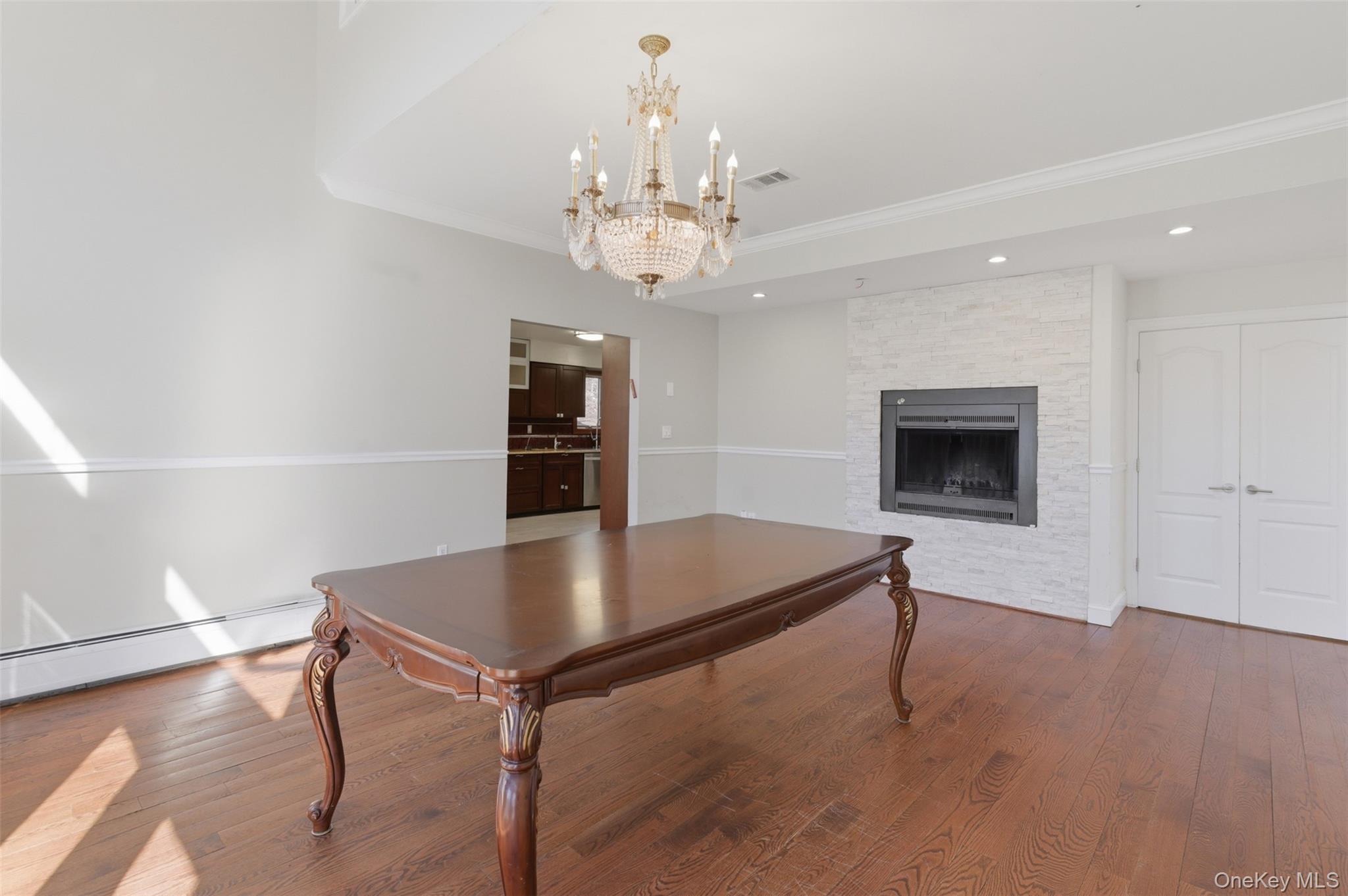 41 South Monsey Road Monsey, NY 10952 - Photo 4 of 50 a living room with stainless steel appliances kitchen island a chandelier and a view of kitchen