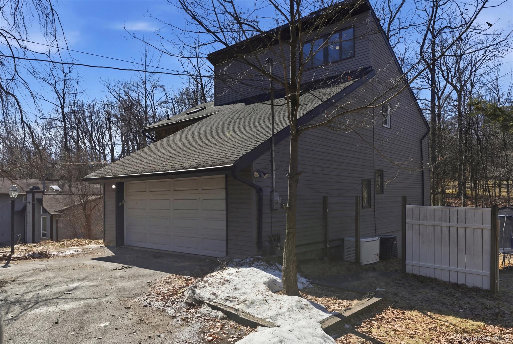 41 South Monsey Road Monsey, NY 10952 - Photo 49 of 50 a backyard of a house with large trees and wooden fence