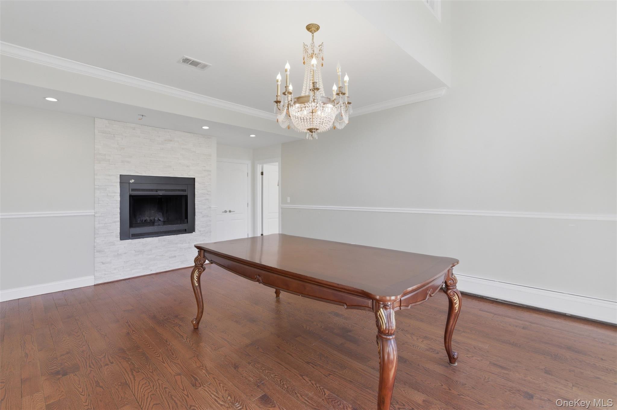 41 South Monsey Road Monsey, NY 10952 - Photo 10 of 50 a living room with a table and a chandelier