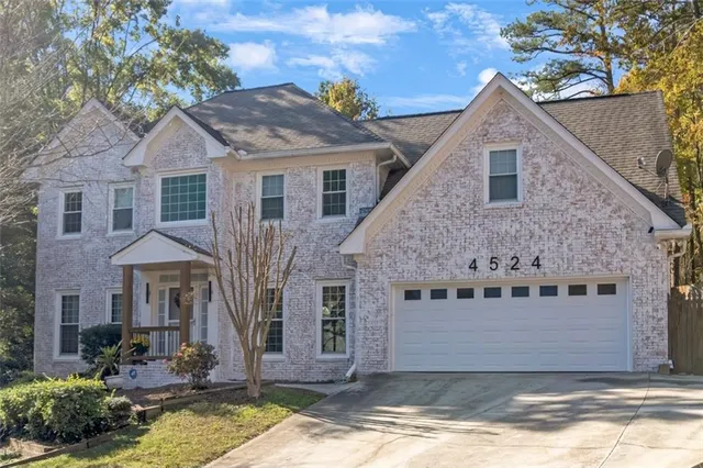 a front view of a house with a yard garage and outdoor seating
