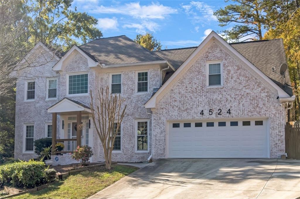 a front view of a house with a yard garage and outdoor seating