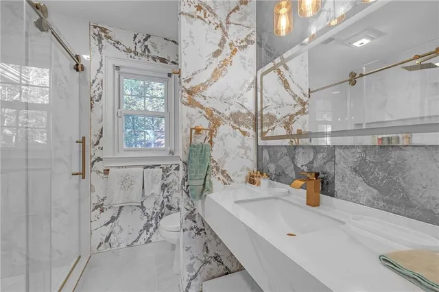 a bathroom with a sink a mirror and shower