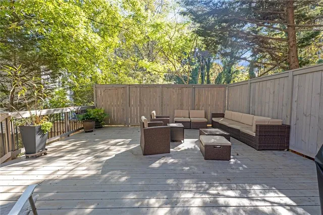 a view of a backyard with furniture and wooden fence
