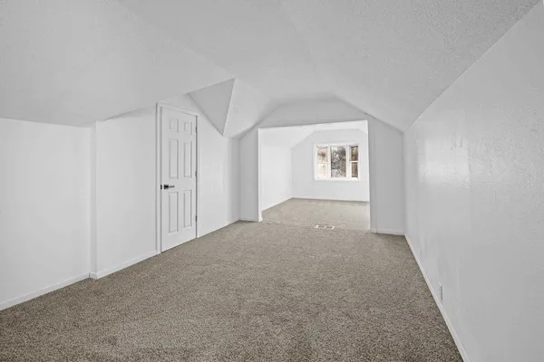 a view of an empty room and a window