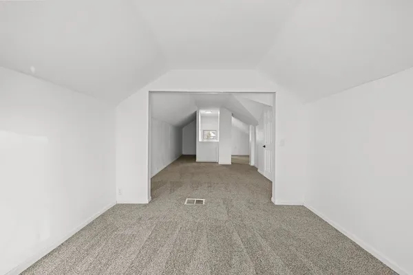 a view of a big room with closet and windows